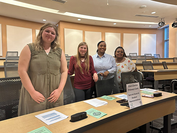 Group of students from the grant writing course posing before their presentation.